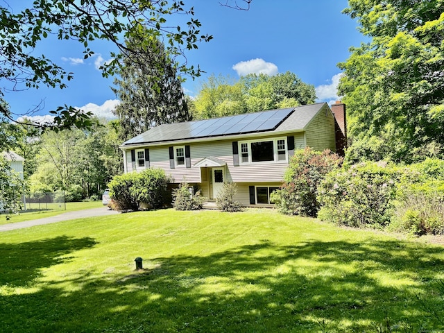 20 Old Hawleyville Rd, Bethel, CT 06801 - raised ranch with solar panels, a chimney, and a front lawn