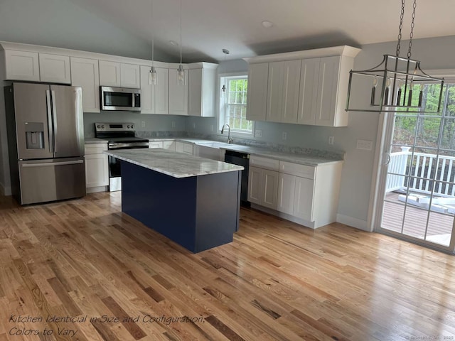 45 Logans Ln, Thompson, CT 06277 - kitchen featuring appliances with stainless steel finishes, light wood-style flooring, a center island, white cabinetry, and vaulted ceiling