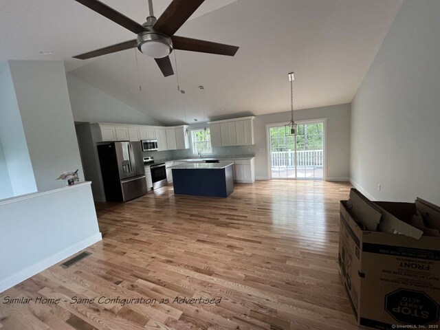 45 Logans Ln, Thompson, CT 06277 - kitchen featuring appliances with stainless steel finishes, open floor plan, ceiling fan, a kitchen island, and light countertops