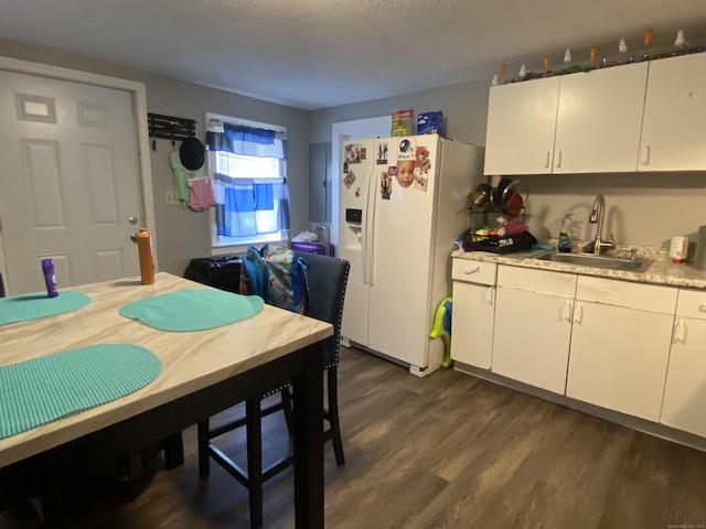 33 Oak St, Derby, CT 06418 - kitchen with a sink, white refrigerator with ice dispenser, dark wood-style flooring, light countertops, and a textured ceiling