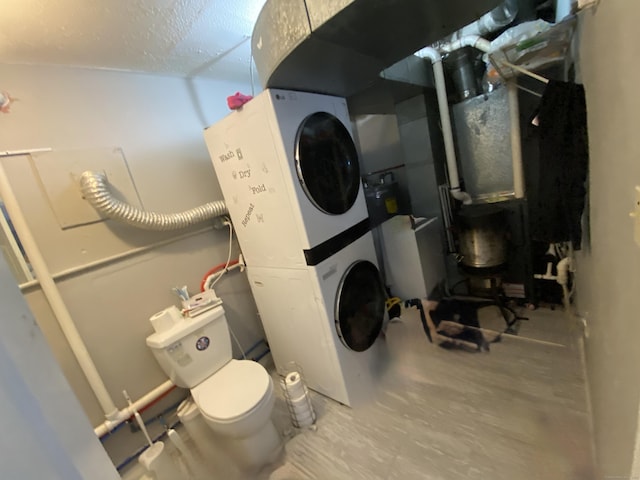 33 Oak St, Derby, CT 06418 - laundry area featuring stacked washer and clothes dryer and a textured ceiling