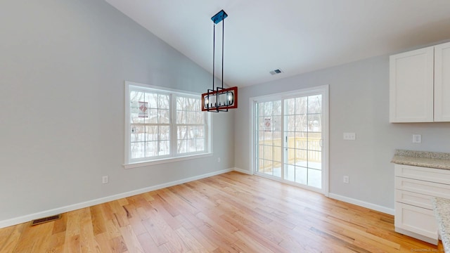 25 First Ave, Enfield, CT 06082 - unfurnished dining area with light wood finished floors, baseboards, and high vaulted ceiling
