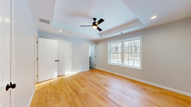 25 First Ave, Enfield, CT 06082 - unfurnished bedroom featuring a tray ceiling, recessed lighting, baseboards, light wood finished floors, and ceiling fan