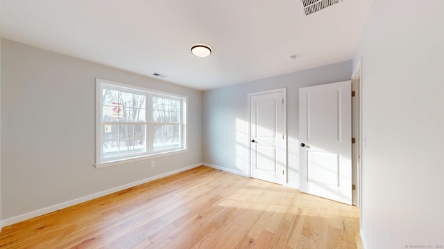 25 First Ave, Enfield, CT 06082 - unfurnished bedroom with light wood-type flooring, baseboards, and a closet