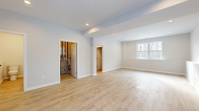 25 First Ave, Enfield, CT 06082 - unfurnished bedroom with light wood finished floors, recessed lighting, baseboards, ensuite bath, and a walk in closet