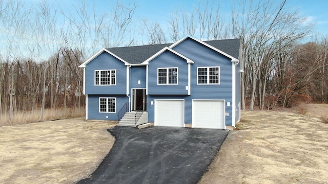 25 First Ave, Enfield, CT 06082 - bi-level home with an attached garage and driveway