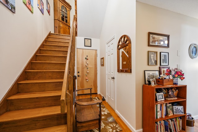 58 Woodley Ct Unit 14, Meriden, CT 06450 - stairway with wood finished floors, baseboards, and vaulted ceiling