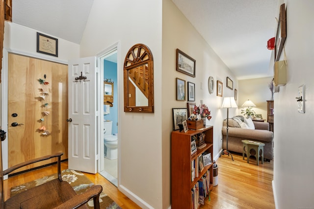 58 Woodley Ct Unit 14, Meriden, CT 06450 - hall with light wood-style floors, lofted ceiling, and baseboards