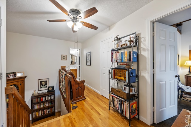 58 Woodley Ct Unit 14, Meriden, CT 06450 - bedroom with light wood finished floors, baseboards, a textured ceiling, and ceiling fan
