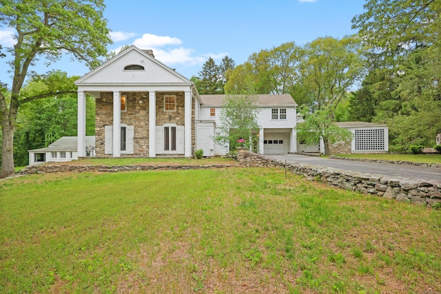 16 Katydid Ln, Weston, CT 06883 - neoclassical / greek revival house with driveway, a garage, stone siding, and a front yard