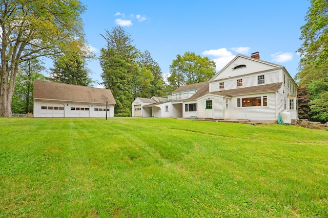 16 Katydid Ln, Weston, CT 06883 - back of property featuring a garage, a chimney, and a lawn