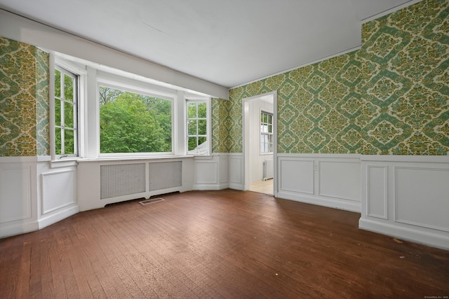 16 Katydid Ln, Weston, CT 06883 - unfurnished room featuring wallpapered walls, wainscoting, plenty of natural light, wood-type flooring, and a decorative wall