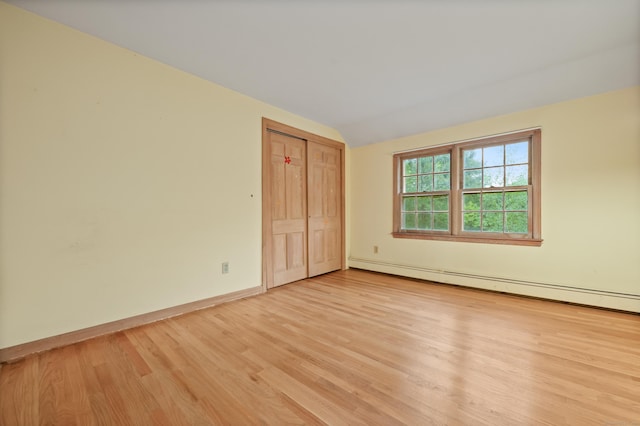 16 Katydid Ln, Weston, CT 06883 - spare room with light wood-type flooring, baseboard heating, lofted ceiling, and baseboards