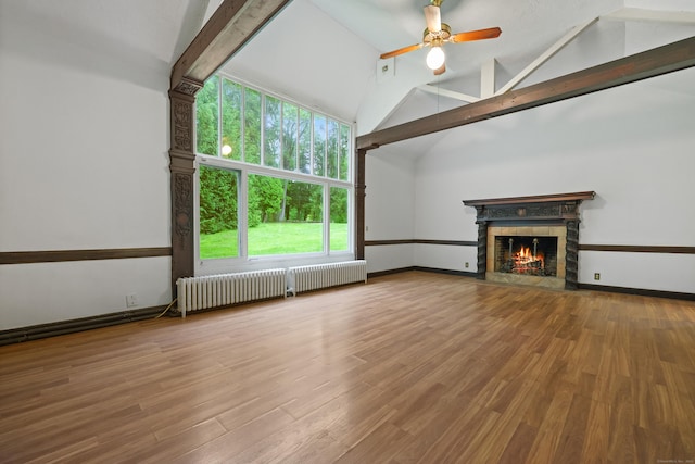 16 Katydid Ln, Weston, CT 06883 - unfurnished living room featuring radiator heating unit, a fireplace with flush hearth, beam ceiling, ceiling fan, and wood finished floors