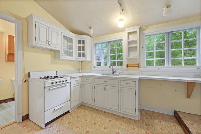 16 Katydid Ln, Weston, CT 06883 - kitchen featuring gas range gas stove, a sink, lofted ceiling, white cabinets, and light countertops