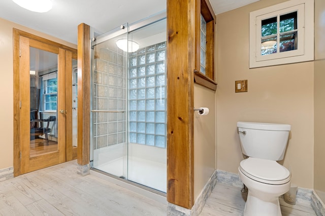 332 Shewville Rd, Ledyard, CT 06339 - bathroom featuring toilet, a stall shower, wood finished floors, and baseboards