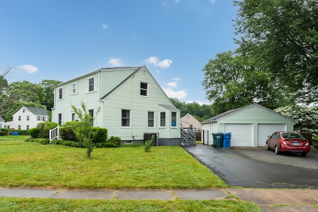 21 Pond Rd, Hamden, CT 06514 - view of front of home with a garage, a front yard, and an outdoor structure