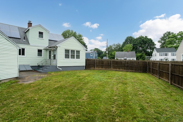 21 Pond Rd, Hamden, CT 06514 - back of house with a fenced backyard, a chimney, and roof with shingles