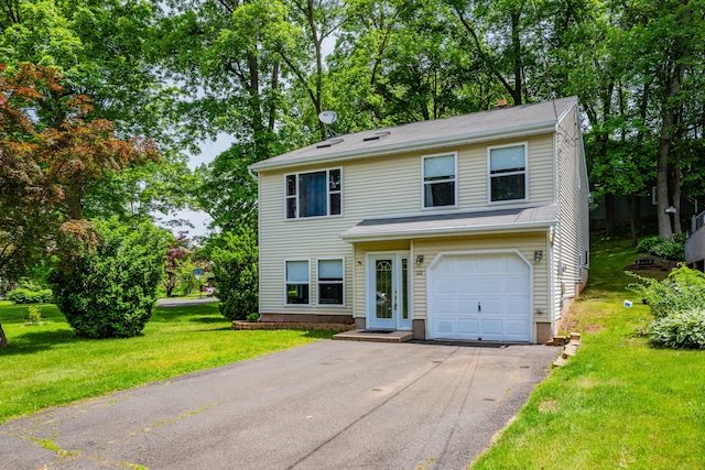 122 Carr Ave, Newington, CT 06111 - traditional-style home featuring an attached garage, asphalt driveway, a front yard, and view of scattered trees