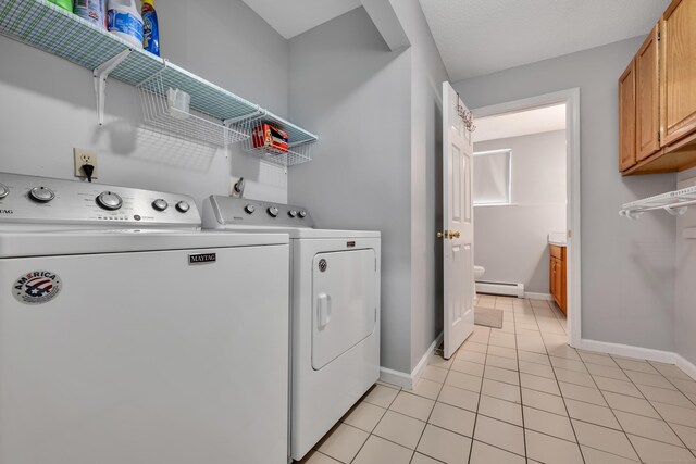122 Carr Ave, Newington, CT 06111 - washroom with baseboard heating, washer and dryer, light tile patterned flooring, and baseboards