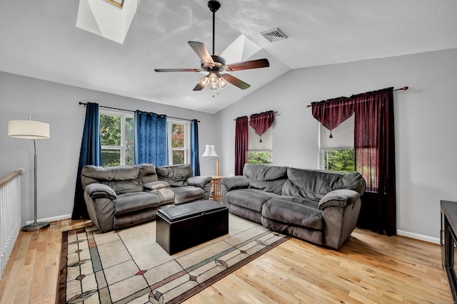 122 Carr Ave, Newington, CT 06111 - living room with a skylight, light wood-type flooring, vaulted ceiling, a ceiling fan, and baseboards