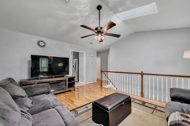 122 Carr Ave, Newington, CT 06111 - living room with a ceiling fan, light wood finished floors, vaulted ceiling, and a skylight