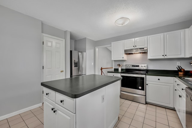122 Carr Ave, Newington, CT 06111 - kitchen with appliances with stainless steel finishes, dark countertops, under cabinet range hood, a kitchen island, and light tile patterned floors