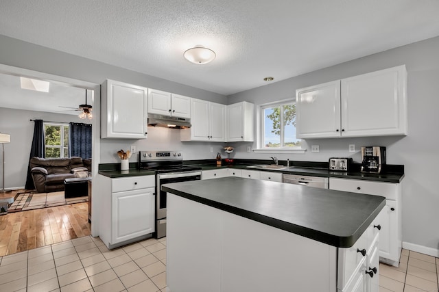 122 Carr Ave, Newington, CT 06111 - kitchen featuring stainless steel appliances, under cabinet range hood, dark countertops, a sink, and white cabinetry