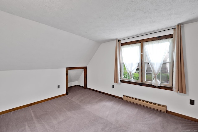 55 Indian Spring Rd, Woodstock, CT 06281 - additional living space with a baseboard radiator, baseboards, carpet flooring, vaulted ceiling, and a textured ceiling