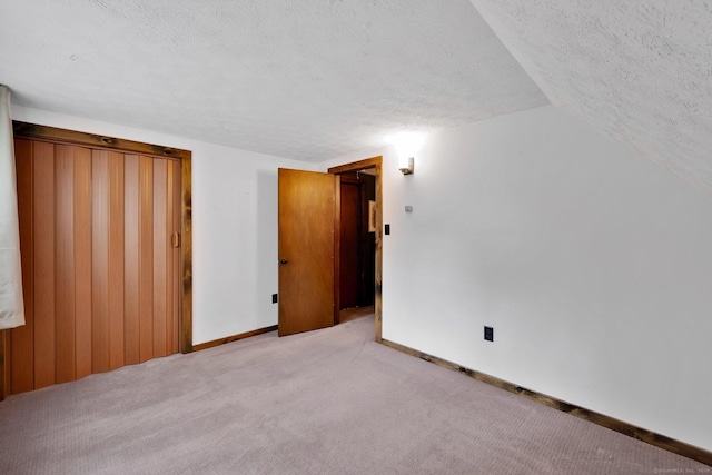 55 Indian Spring Rd, Woodstock, CT 06281 - unfurnished bedroom featuring a textured ceiling, carpet floors, lofted ceiling, and baseboards