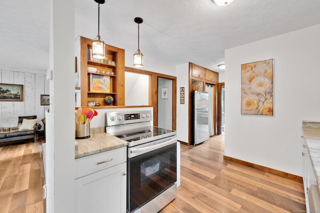 55 Indian Spring Rd, Woodstock, CT 06281 - kitchen featuring stainless steel appliances, light wood finished floors, baseboards, a textured ceiling, and pendant lighting