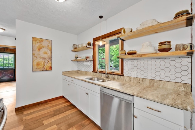 55 Indian Spring Rd, Woodstock, CT 06281 - kitchen featuring stainless steel dishwasher, open shelves, light wood-type flooring, decorative backsplash, and white cabinetry