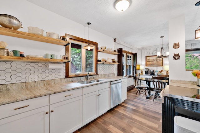 55 Indian Spring Rd, Woodstock, CT 06281 - kitchen featuring open shelves, stainless steel dishwasher, wood finished floors, a sink, and white cabinetry