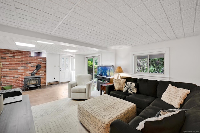 55 Indian Spring Rd, Woodstock, CT 06281 - living area featuring a wood stove, wood finished floors, and a baseboard heating unit