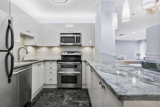 1633 Washington Blvd Unit 3A, Stamford, CT 06902 - kitchen featuring stainless steel appliances, a sink, a peninsula, dark marble finish flooring, and backsplash