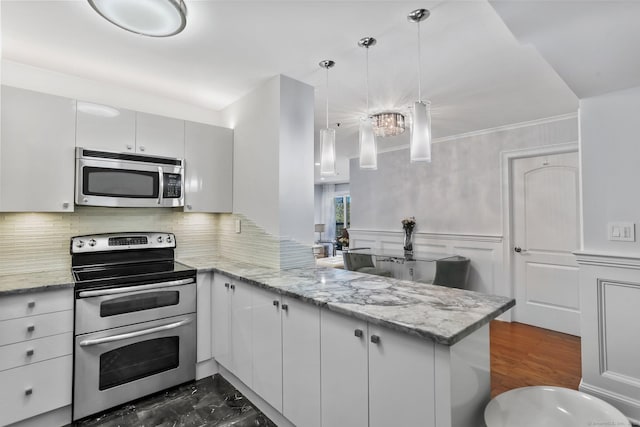 1633 Washington Blvd Unit 3A, Stamford, CT 06902 - kitchen with appliances with stainless steel finishes, a peninsula, tasteful backsplash, light stone countertops, and a wainscoted wall