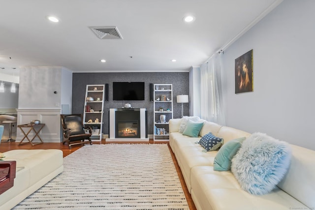 1633 Washington Blvd Unit 3A, Stamford, CT 06902 - living area with crown molding, wood finished floors, recessed lighting, built in features, and a glass covered fireplace