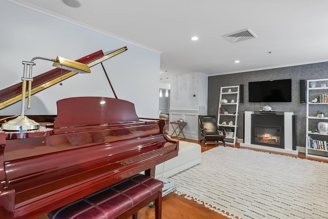 1633 Washington Blvd Unit 3A, Stamford, CT 06902 - sitting room featuring crown molding, wood finished floors, built in shelves, a glass covered fireplace, and recessed lighting