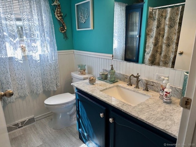 23 N Rd, Southington, CT 06489 - bathroom with toilet, wood finished floors, vanity, and a wainscoted wall