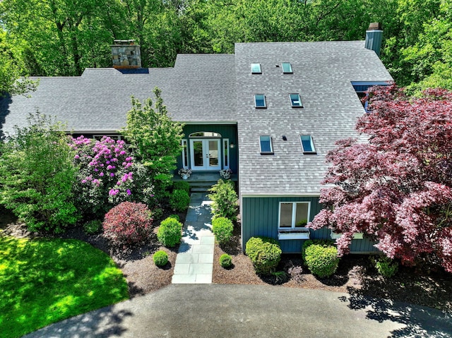66 Penny Ln, Woodbridge, CT 06525 - view of front of house featuring a chimney, french doors, a shingled roof, and board and batten siding