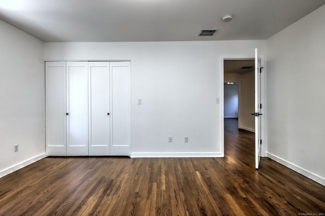 66 Penny Ln, Woodbridge, CT 06525 - unfurnished bedroom with dark wood finished floors, baseboards, and a closet