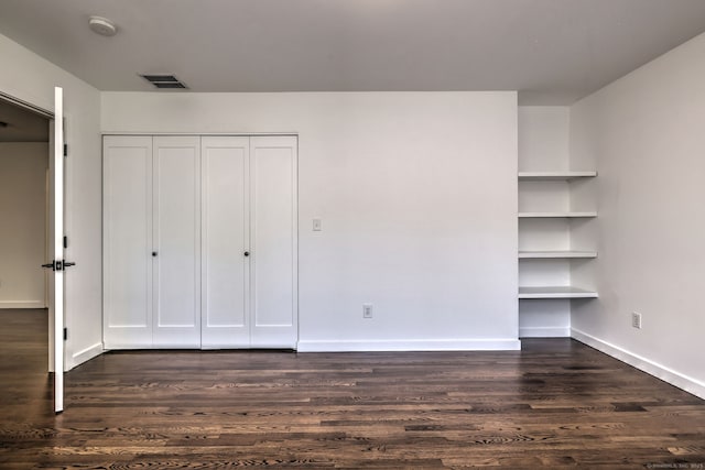 66 Penny Ln, Woodbridge, CT 06525 - unfurnished bedroom with dark wood-style flooring, a closet, and baseboards