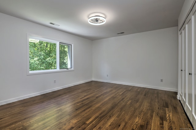 66 Penny Ln, Woodbridge, CT 06525 - unfurnished bedroom with dark wood-style floors, baseboards, and a closet