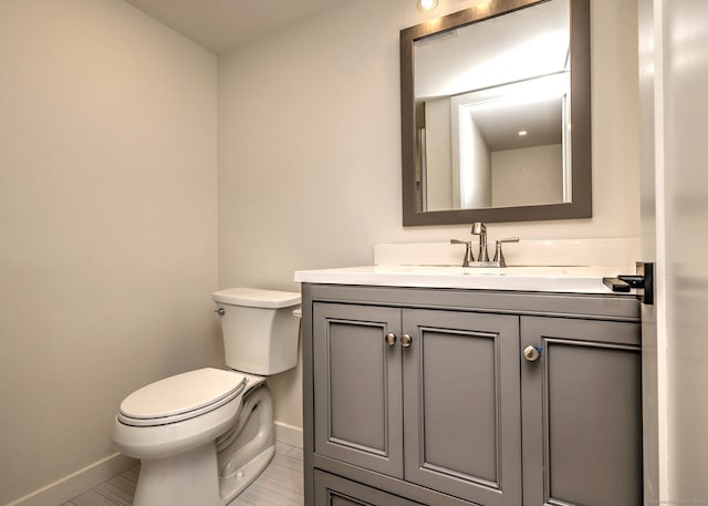 66 Penny Ln, Woodbridge, CT 06525 - bathroom featuring baseboards, toilet, vanity, and tile patterned floors