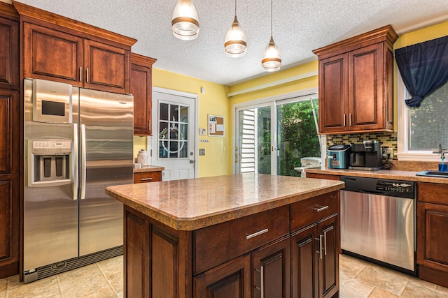 15 Brittany Dr, Durham, CT 06422 - kitchen with stainless steel appliances, a center island, a sink, decorative light fixtures, and backsplash