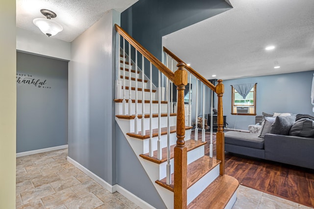 15 Brittany Dr, Durham, CT 06422 - staircase with a textured ceiling, baseboards, cooling unit, and stone finish floors