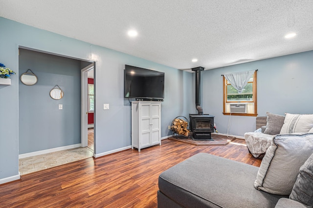 15 Brittany Dr, Durham, CT 06422 - living room featuring wood finished floors, a wood stove, a textured ceiling, recessed lighting, and cooling unit