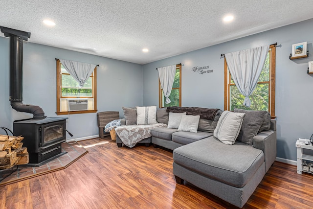 15 Brittany Dr, Durham, CT 06422 - living area with a wood stove, wood finished floors, recessed lighting, a textured ceiling, and cooling unit