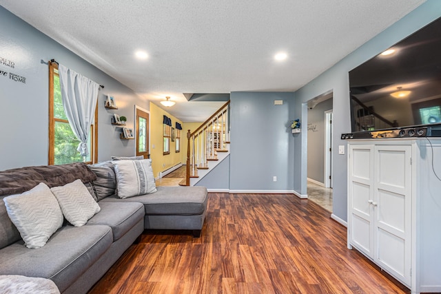 15 Brittany Dr, Durham, CT 06422 - living area with wood finished floors, stairs, a textured ceiling, a baseboard heating unit, and recessed lighting
