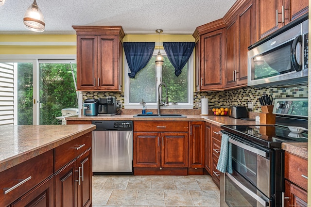 15 Brittany Dr, Durham, CT 06422 - kitchen with stainless steel appliances, a sink, decorative backsplash, hanging light fixtures, and a textured ceiling